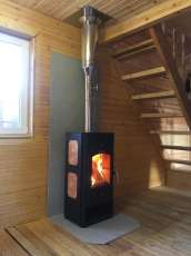 Популярный камин с дровницей Сибирь 8 в интерьере фото в Бресте