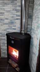 Стальной недорогой камин Теплодар ОВ-120 (угловой) фото в интерьере в Бресте