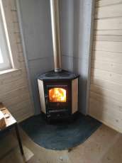 Недорогая печь-камин со стеклом Бавария угловая с плитой фото в интерьере в Бресте